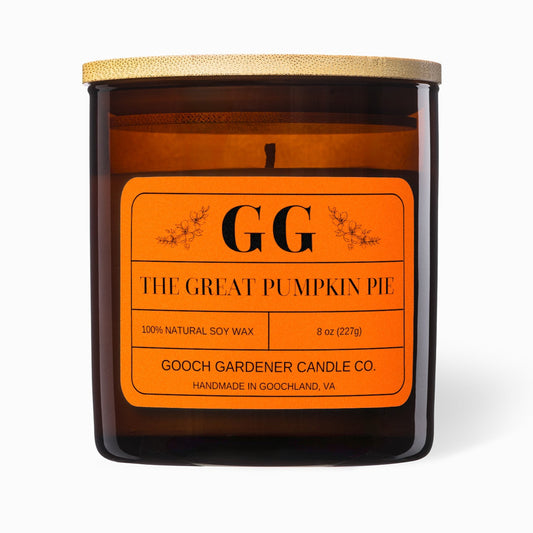 Candle with orange label featuring 'GG' on a white background