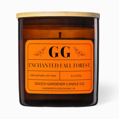Candle with orange label featuring 'GG' branding on a white background