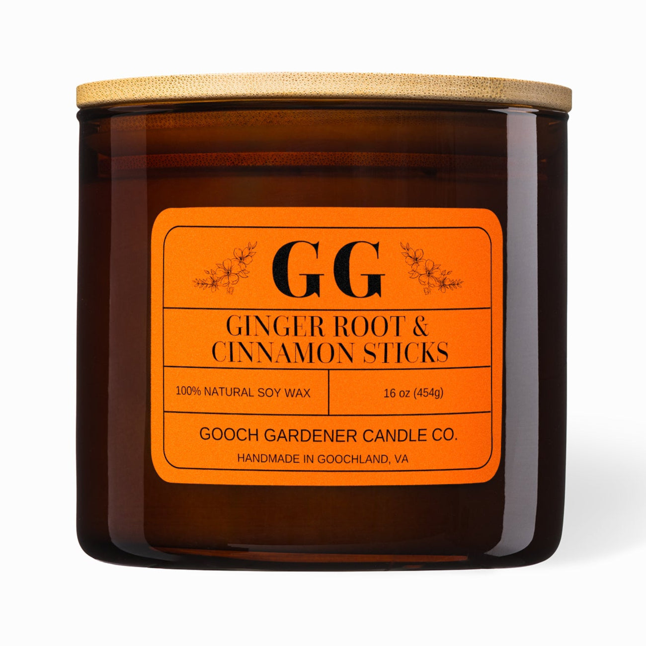 Gooch Gardener Candle Co. ginger root &amp; cinnamon sticks candle with orange label on a white background