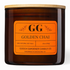 An amber glass jar candle with a light wood lid and a bright orange label reading &