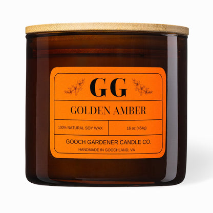 Gooch Gardener Candle Co. Golden Amber candle with orange label on a white background