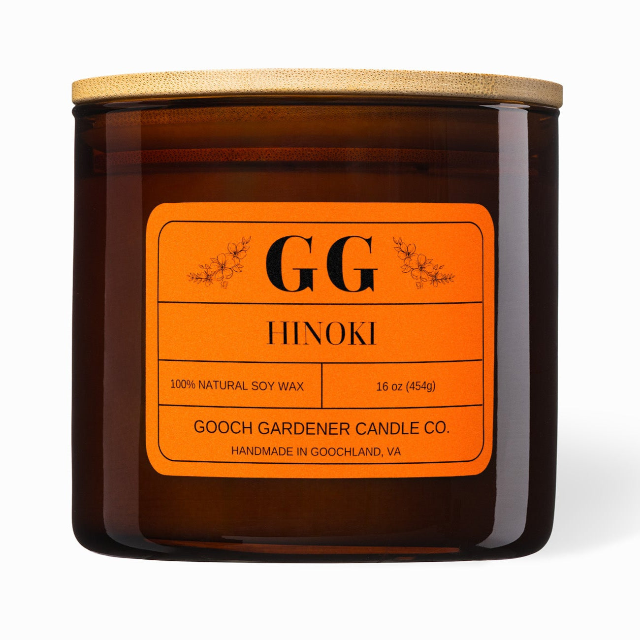 Gooch Gardener Candle Co. Hinoki candle with orange label on a white background