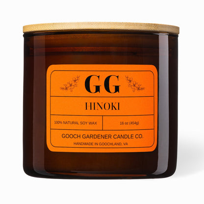 Gooch Gardener Candle Co. Hinoki candle with orange label on a white background