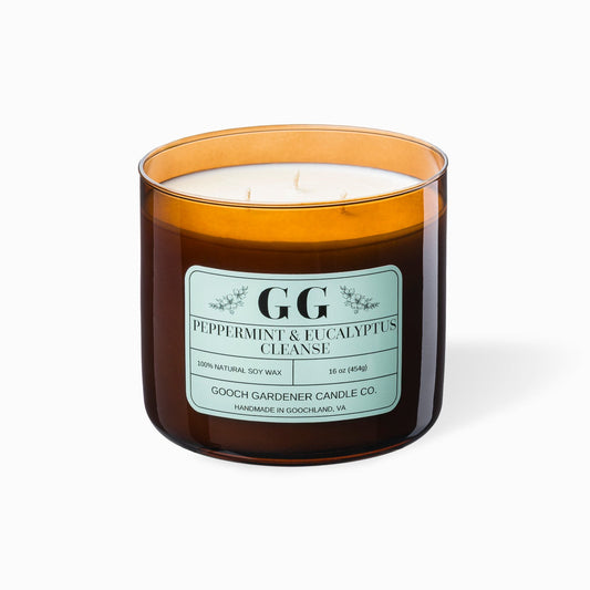 Candle with an amber glass jar and a label on a white background