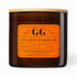 Brown candle with orange label featuring &
