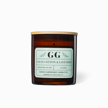 Candle with a label reading 'GG Clean Cotton & Lavender' by Gooch Gardener Candle Co. on a white background.